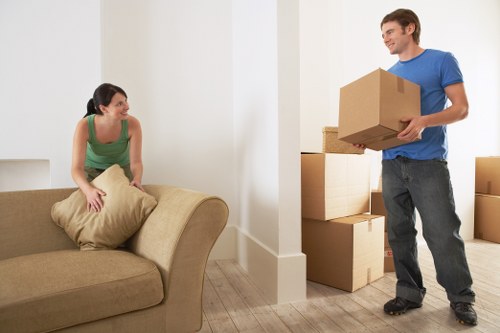 Local office moving team handling furniture access on a Belsize Park street